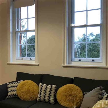 Vertical sliding secondary glazing